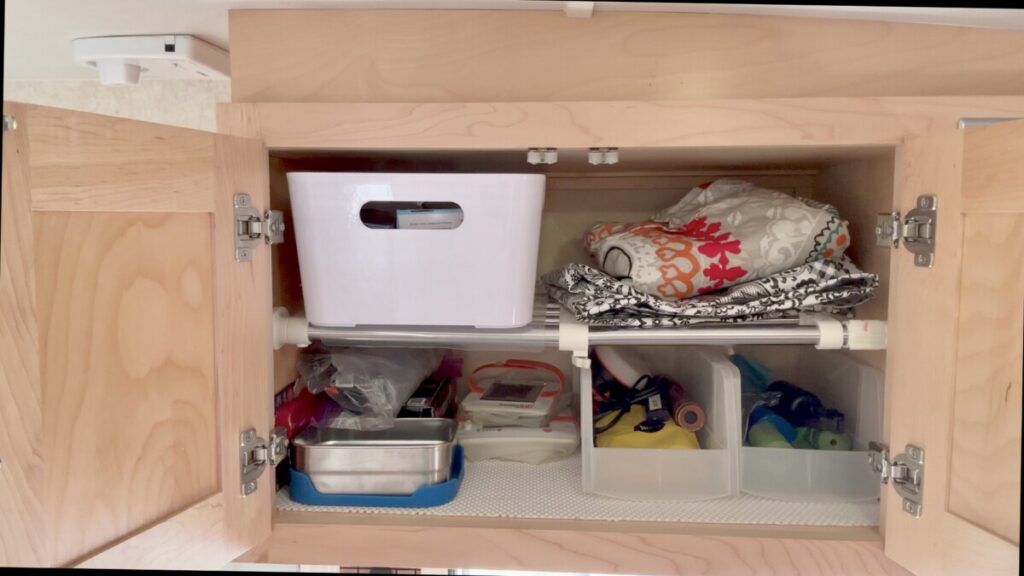 https://randisadventures.com/wp-content/uploads/2023/04/RV-Storage-Idea-using-expandable-shelf-1024x576.jpg